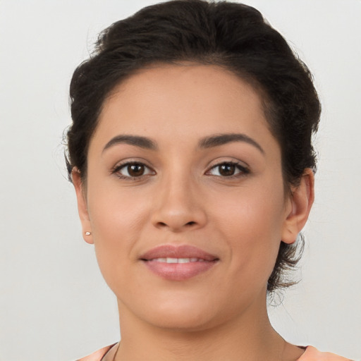 Joyful latino young-adult female with medium  brown hair and brown eyes