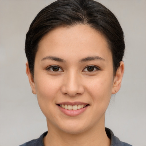 Joyful white young-adult female with medium  brown hair and brown eyes