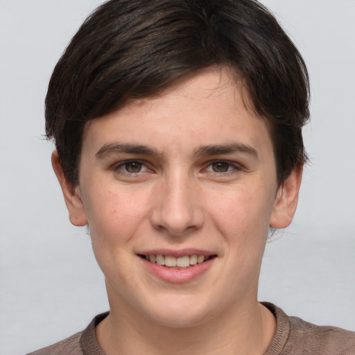 Joyful white young-adult female with short  brown hair and grey eyes