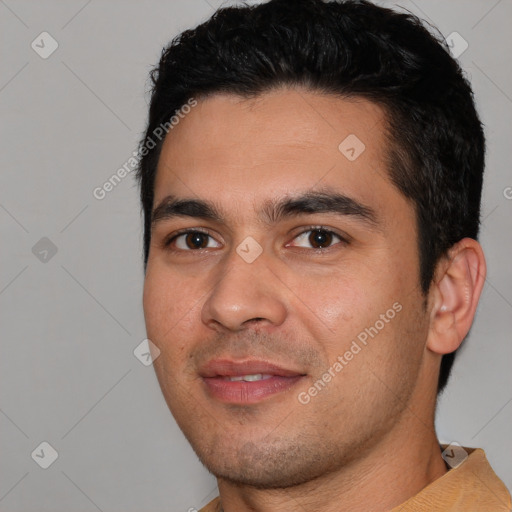 Joyful white young-adult male with short  black hair and brown eyes