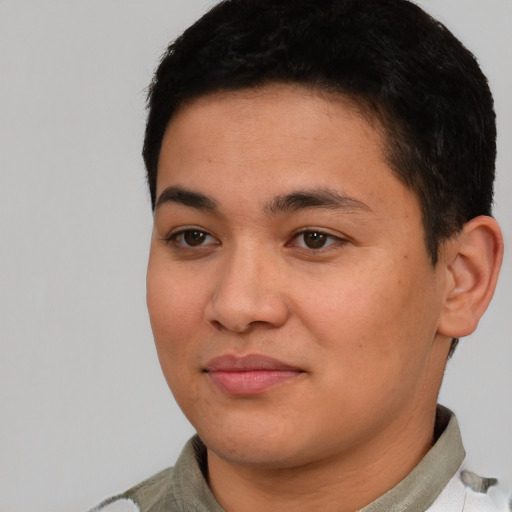 Joyful latino young-adult male with short  brown hair and brown eyes