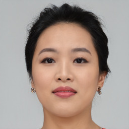 Joyful asian young-adult female with medium  black hair and brown eyes