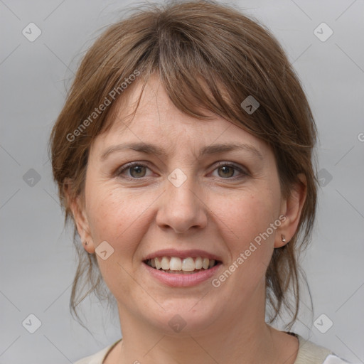 Joyful white adult female with medium  brown hair and grey eyes