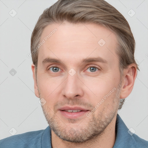 Joyful white adult male with short  brown hair and blue eyes