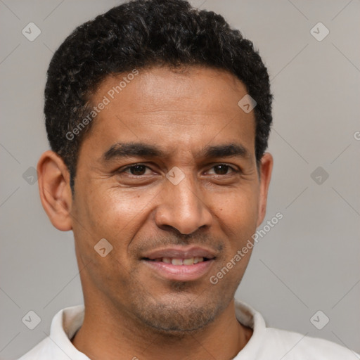 Joyful black adult male with short  brown hair and brown eyes