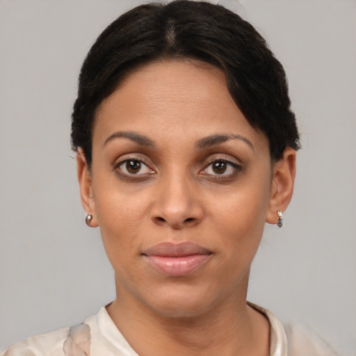 Joyful latino young-adult female with short  brown hair and brown eyes