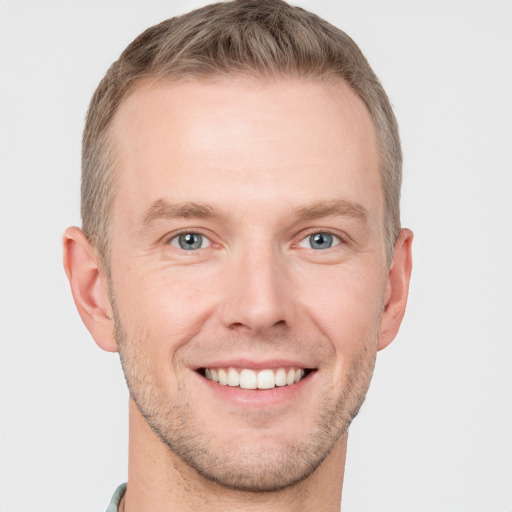 Joyful white adult male with short  brown hair and grey eyes