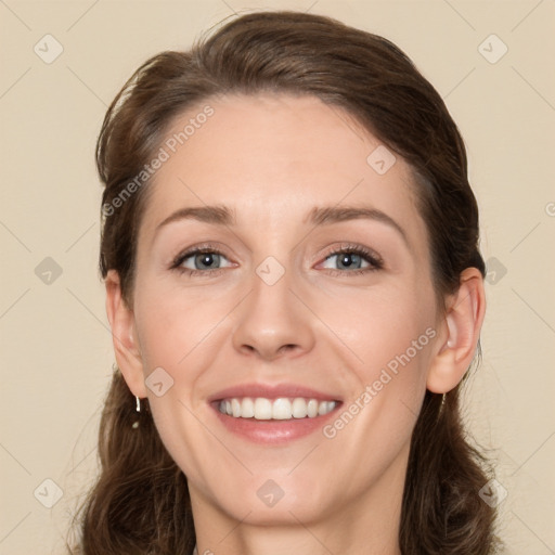 Joyful white young-adult female with medium  brown hair and green eyes