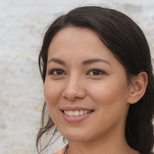 Joyful asian young-adult female with long  brown hair and brown eyes