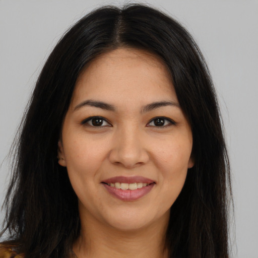 Joyful latino young-adult female with long  brown hair and brown eyes