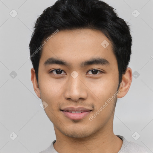 Joyful asian young-adult male with short  black hair and brown eyes