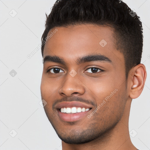 Joyful black young-adult male with short  brown hair and brown eyes