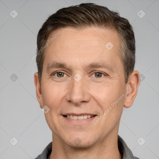 Joyful white adult male with short  brown hair and brown eyes