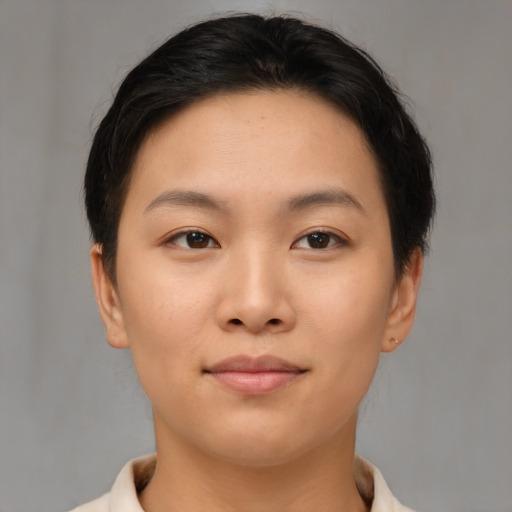 Joyful asian young-adult female with short  brown hair and brown eyes