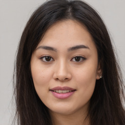 Joyful asian young-adult female with long  brown hair and brown eyes