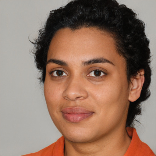 Joyful latino young-adult female with medium  black hair and brown eyes