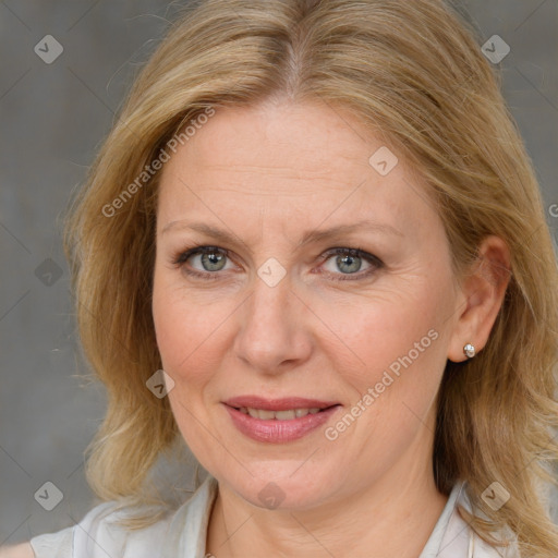 Joyful white adult female with medium  brown hair and blue eyes