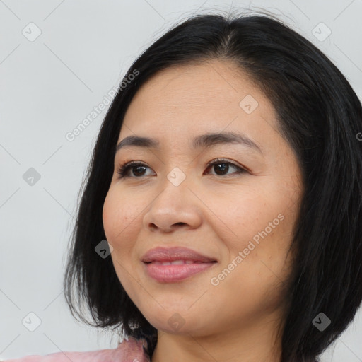 Joyful asian young-adult female with medium  black hair and brown eyes