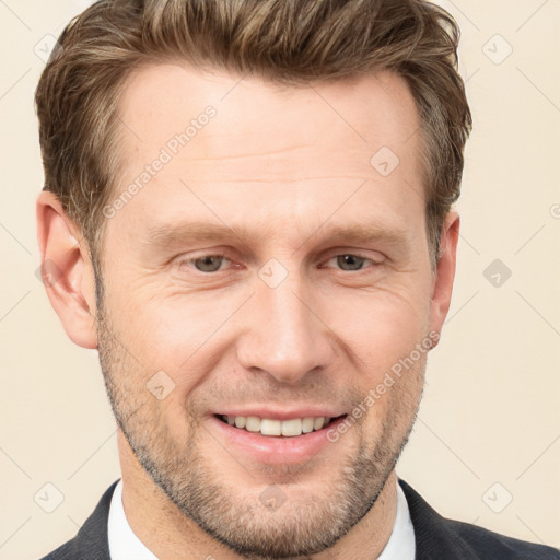 Joyful white adult male with short  brown hair and grey eyes