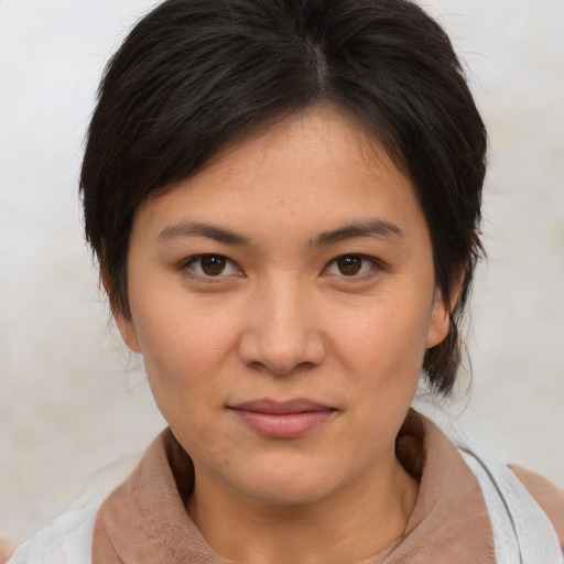 Joyful asian young-adult female with medium  brown hair and brown eyes