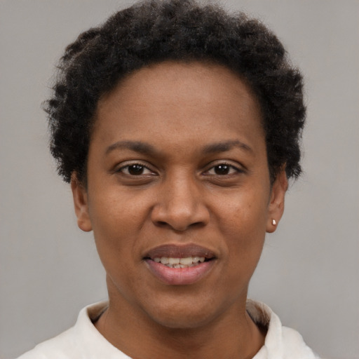 Joyful black young-adult female with short  brown hair and brown eyes