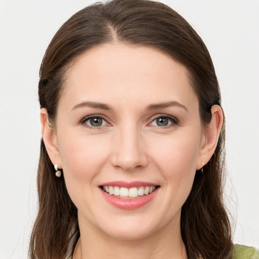 Joyful white young-adult female with long  brown hair and brown eyes