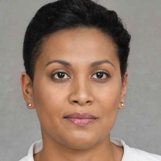 Joyful black young-adult female with short  brown hair and brown eyes