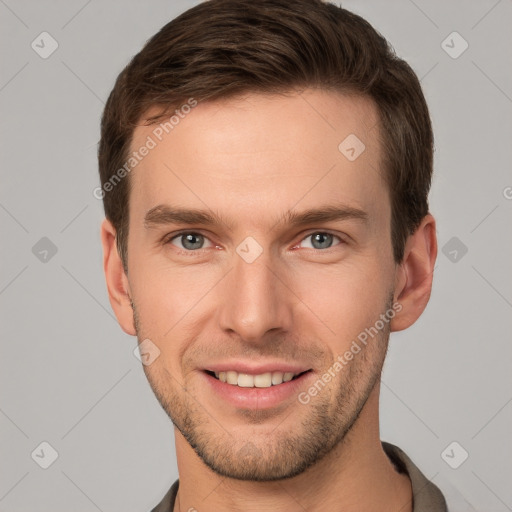 Joyful white young-adult male with short  brown hair and grey eyes