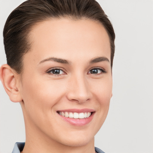 Joyful white young-adult female with medium  brown hair and brown eyes