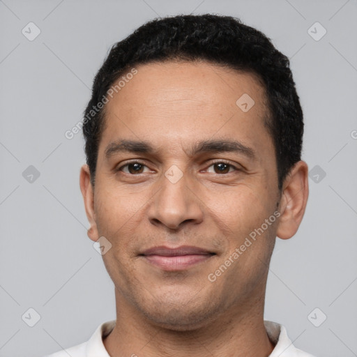 Joyful white young-adult male with short  black hair and brown eyes