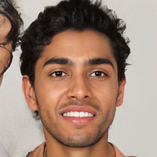 Joyful latino young-adult male with short  black hair and brown eyes