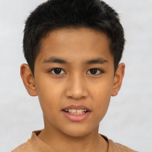 Joyful asian child male with short  brown hair and brown eyes