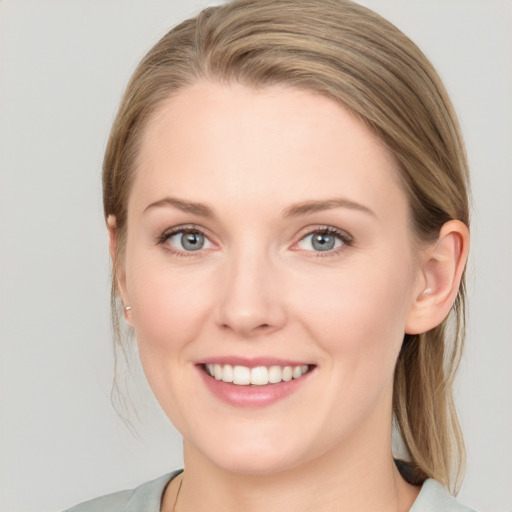 Joyful white young-adult female with medium  brown hair and blue eyes