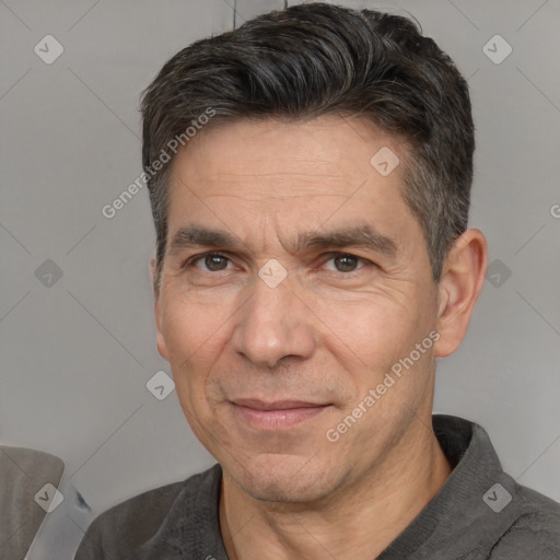 Joyful white adult male with short  black hair and brown eyes