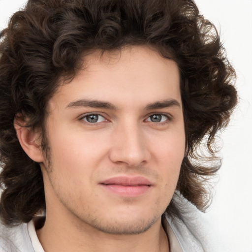 Joyful white young-adult male with medium  brown hair and brown eyes