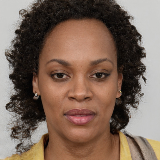 Joyful black adult female with short  brown hair and brown eyes