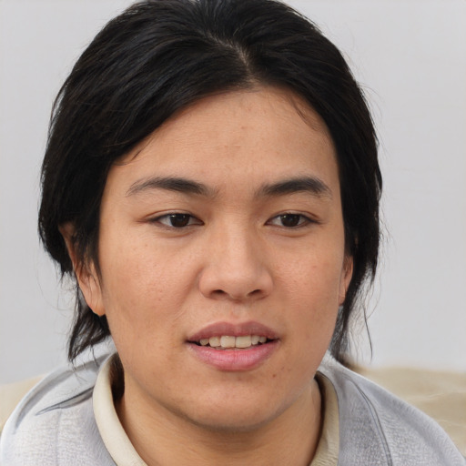 Joyful asian young-adult female with medium  brown hair and brown eyes