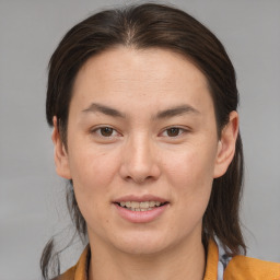 Joyful white young-adult female with medium  brown hair and brown eyes