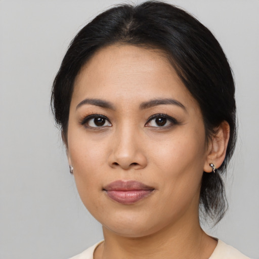 Joyful asian young-adult female with medium  brown hair and brown eyes