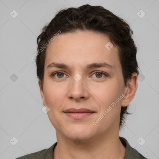 Joyful white adult female with short  brown hair and grey eyes