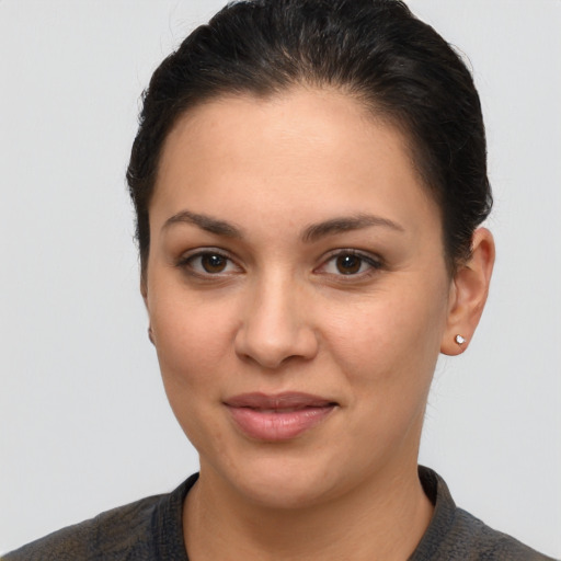 Joyful latino young-adult female with short  brown hair and brown eyes