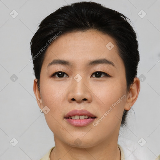 Joyful asian young-adult female with short  black hair and brown eyes