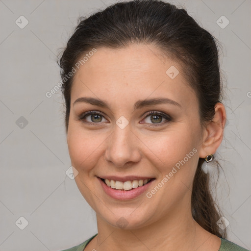 Joyful white young-adult female with medium  brown hair and grey eyes