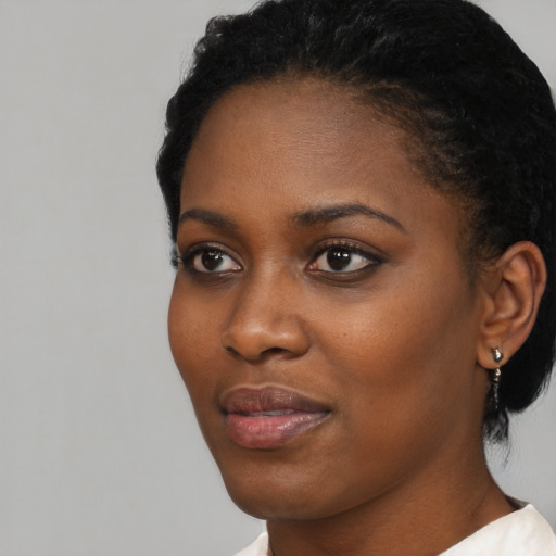 Neutral black young-adult female with short  black hair and brown eyes