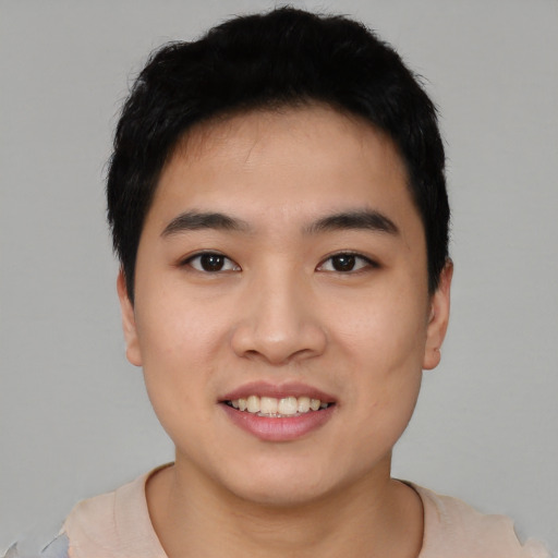 Joyful asian young-adult male with short  black hair and brown eyes