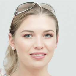 Joyful white young-adult female with long  brown hair and blue eyes