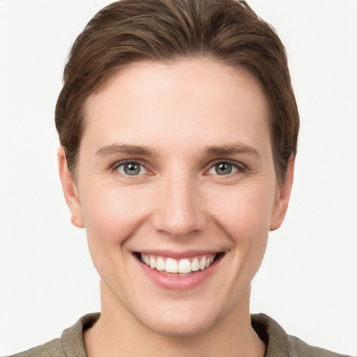 Joyful white young-adult female with short  brown hair and grey eyes