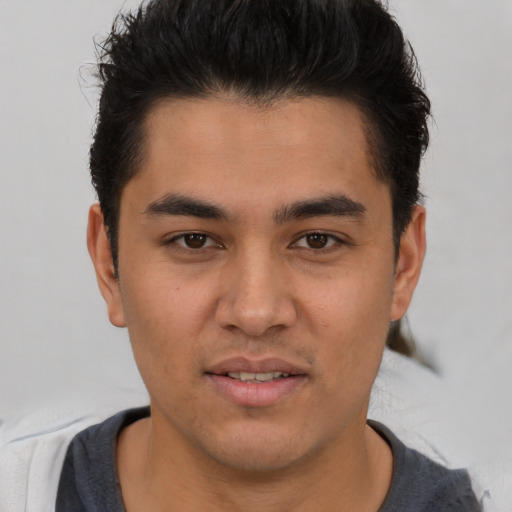 Joyful latino young-adult male with short  brown hair and brown eyes