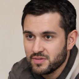 Joyful white young-adult male with short  black hair and brown eyes