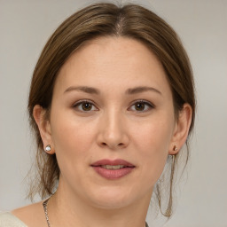 Joyful white adult female with medium  brown hair and brown eyes